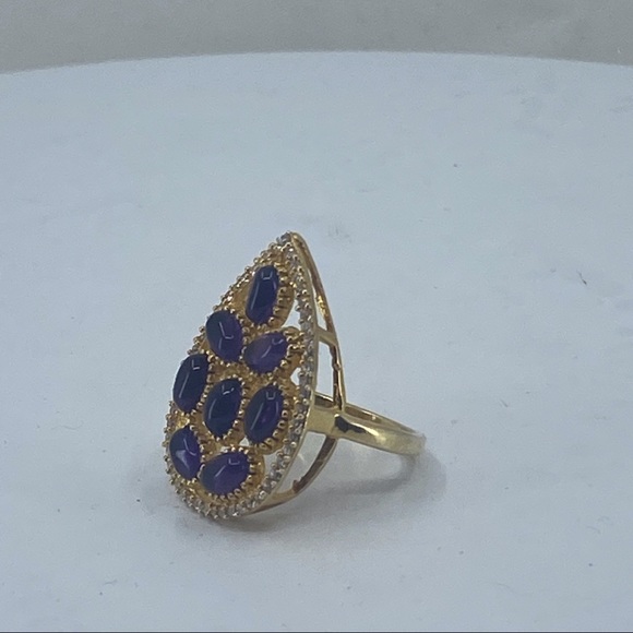 Sterling silver ring with gold tone finish. It is accented with 8 oval stones. - Picture 4 of 5